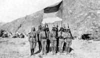 Arab rebels with the British-designed Flag of the Arab Revolt